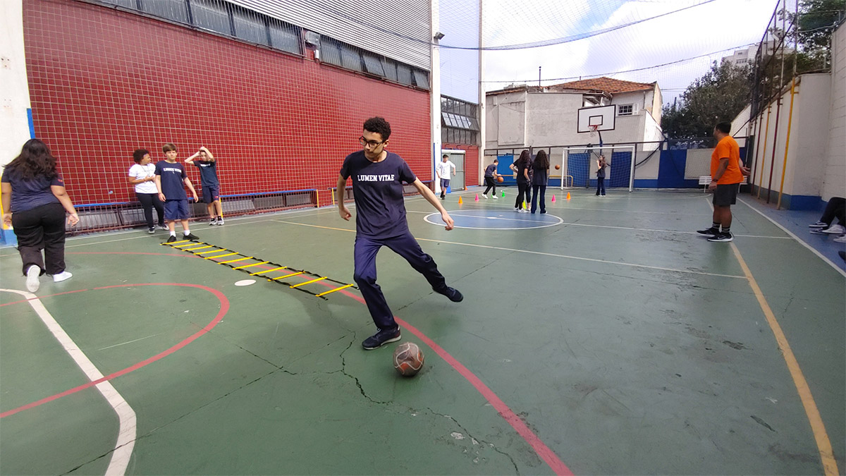 Foto de alunos reunidos em quadra esportiva